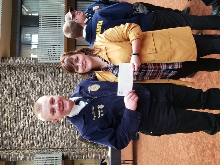 Jayce recieving his expansion grant from  ND FFA foundation